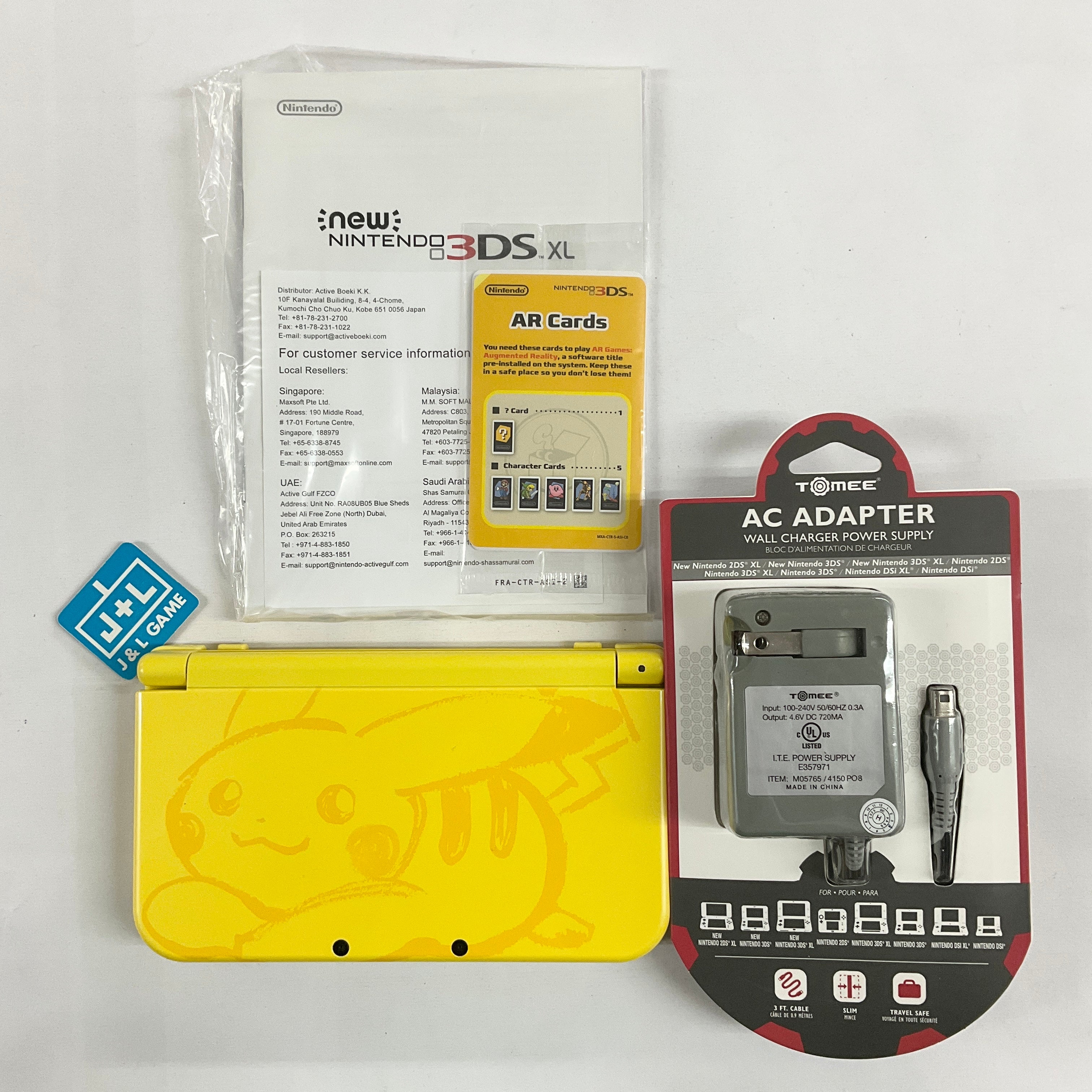 Nintendo 3DS XL with Pikachu case and game with outlets charger cord